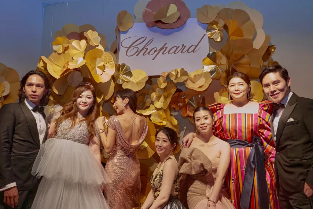 Guests pose with Chopard backdrop