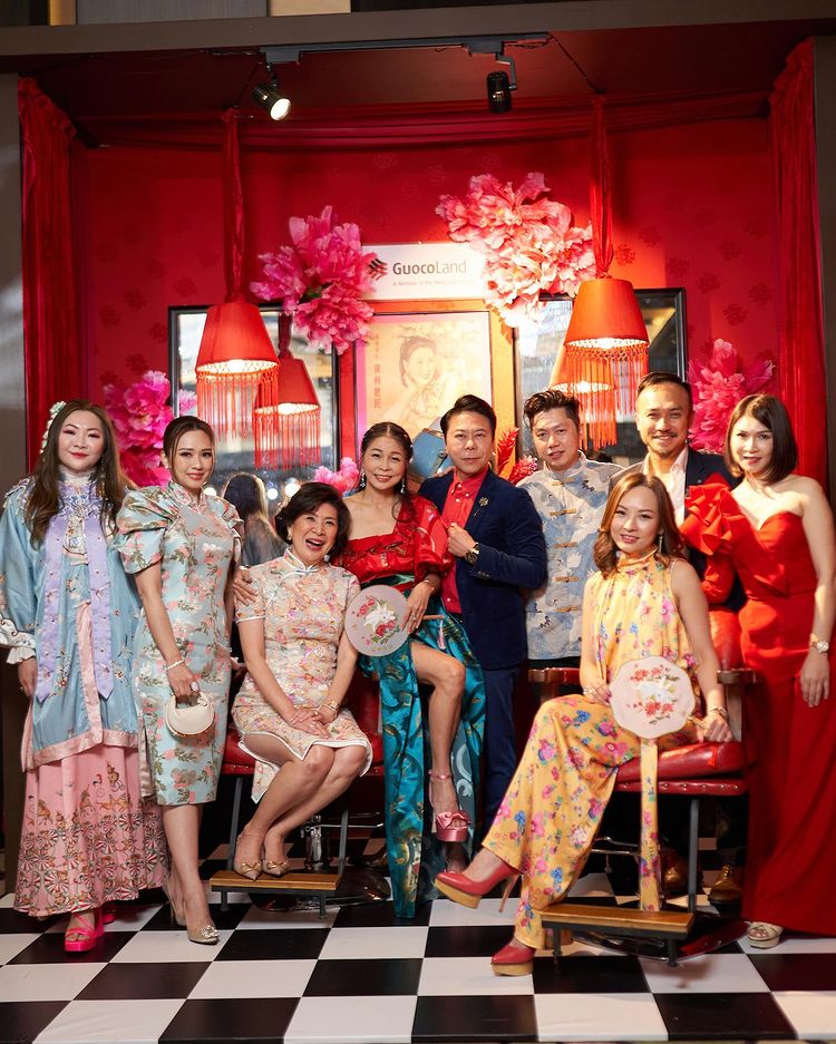 Guests pose with the GuocoLand Hair Salon backdrop at PINCNY2023 event